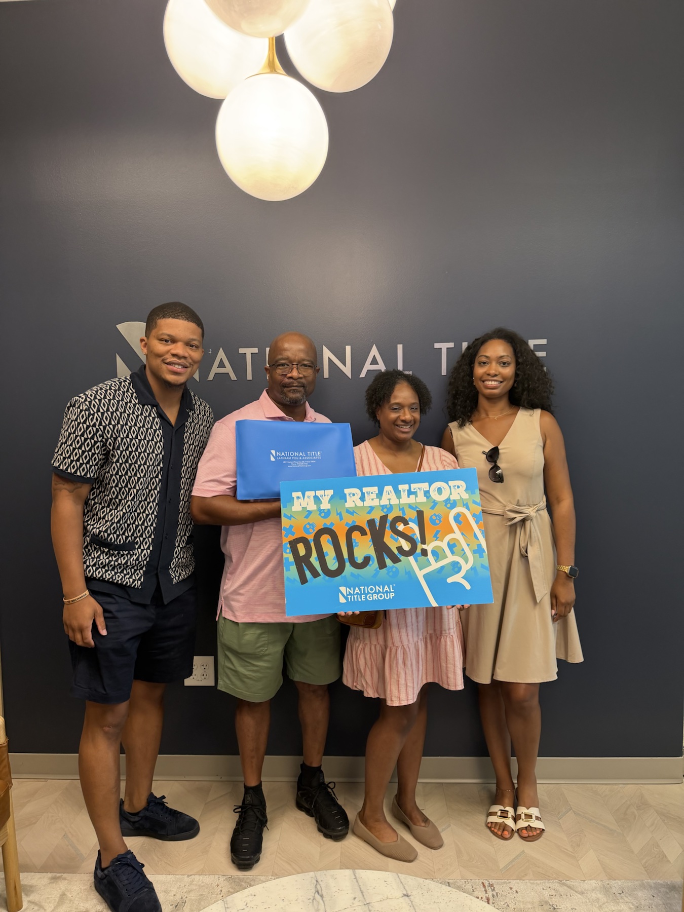 Jose Moore Jr. celebrating a client mortgage closing at National Title Group